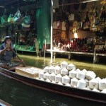 Coconut merchant at a floating market.